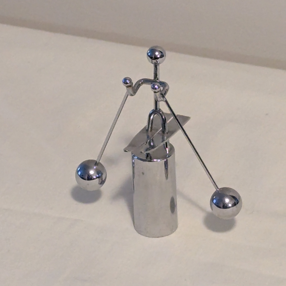 Vintage mod metal balancing kinetic skier Chrome. Perpetual Motion.
